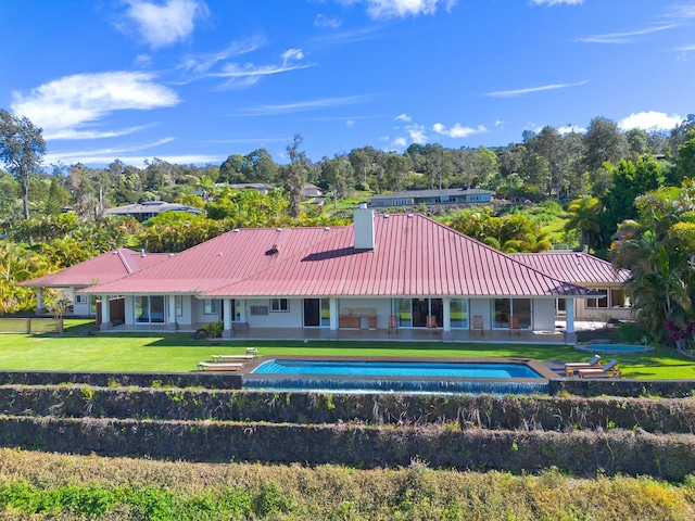 73-4558 Kukuki St, Kailua-Kona, HI 96740 - back of house with a metal roof, an outdoor pool, a yard, and a patio area