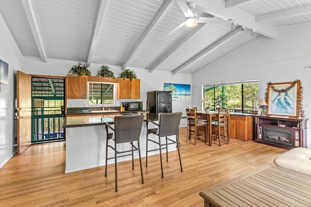 14-3531 Nanawale Blvd, Pahoa, HI 96778 - kitchen with black appliances, a sink, light wood-type flooring, dark countertops, and brown cabinets