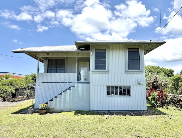 1969-A Kilauea Ave, Hilo, HI 96720 - view of front of house featuring stairway, a front yard, and a metal roof