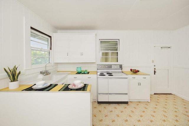 1969-A Kilauea Ave, Hilo, HI 96720 - kitchen with white electric stove, white cabinetry, and light countertops