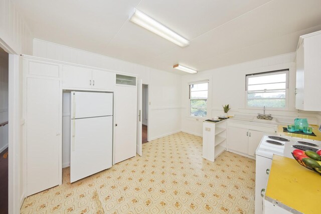 1969-A Kilauea Ave, Hilo, HI 96720 - kitchen with white appliances, white cabinetry, and light countertops