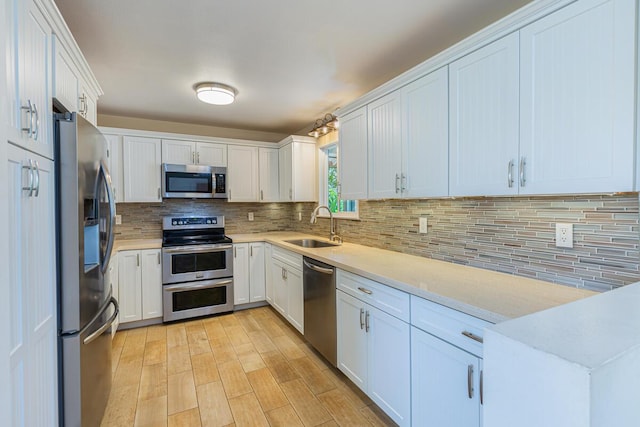 5372 Kumole St, Kapaa, HI 96746 - kitchen featuring stainless steel appliances, a sink, light countertops, and backsplash