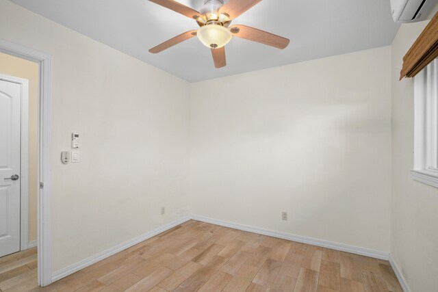 5372 Kumole St, Kapaa, HI 96746 - spare room featuring light wood-style flooring, a wall mounted air conditioner, baseboards, and a ceiling fan