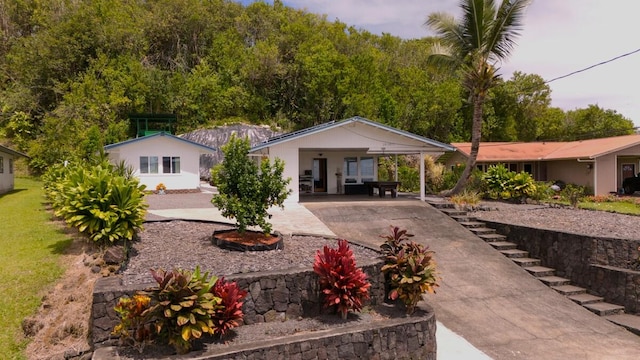 28-2855 Onomea Pl, Pepeekeo, HI 96783 - rear view of house with driveway and an attached carport