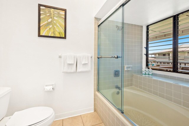 1565 Pee Rd Unit 221, Koloa, HI 96756 - bathroom featuring toilet, tile patterned floors, tiled shower / bath combo, and baseboards