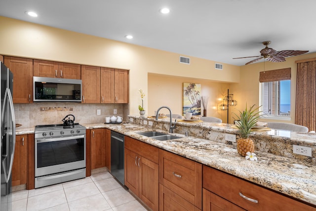 75-6060 Kuakini Hwy Unit B1, Kailua-Kona, HI 96740 - kitchen featuring appliances with stainless steel finishes, brown cabinets, light stone counters, tasteful backsplash, and recessed lighting