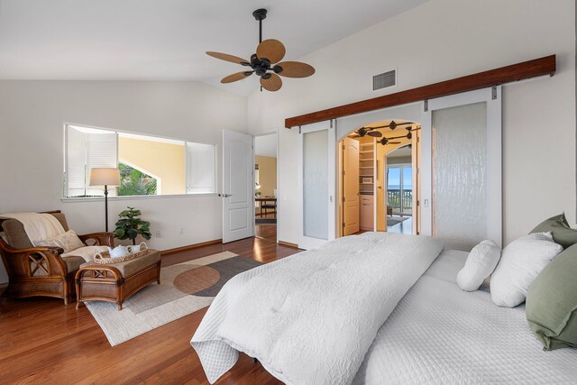 75-6060 Kuakini Hwy Unit B1, Kailua-Kona, HI 96740 - bedroom with wood finished floors, vaulted ceiling, arched walkways, access to outside, and a ceiling fan