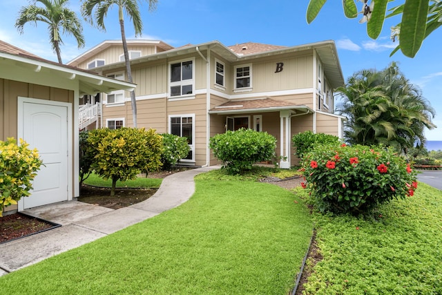 75-6060 Kuakini Hwy Unit B1, Kailua-Kona, HI 96740 - view of front of home with a front yard and board and batten siding
