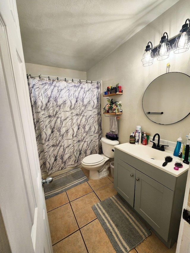 272 Kapiolani St Unit 203, Hilo, HI 96720 - bathroom with toilet, vanity, tile patterned floors, a textured ceiling, and curtained shower