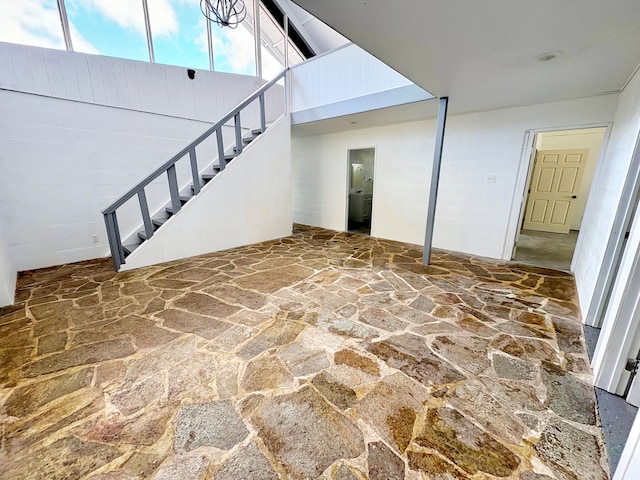 16-2122 Ginger Ln, Pahoa, HI 96778 - unfurnished living room featuring stone flooring, stairs, and a high ceiling