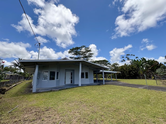 16-2122 Ginger Ln, Pahoa, HI 96778 - back of property featuring a lawn, an attached carport, driveway, and a patio