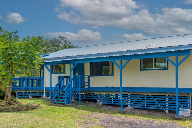 16-2103 Kuleana St, Pahoa, HI 96778 - view of front of house with a metal roof and a wooden deck