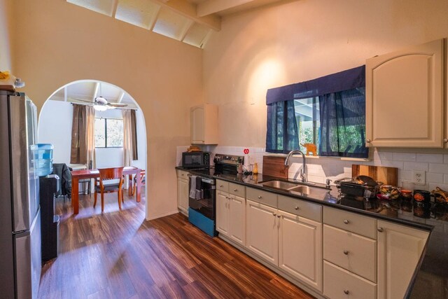 16-2103 Kuleana St, Pahoa, HI 96778 - kitchen featuring appliances with stainless steel finishes, dark countertops, dark wood-style floors, white cabinets, and high vaulted ceiling