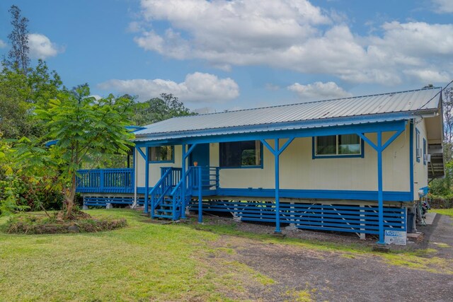 16-2103 Kuleana St, Pahoa, HI 96778 - view of front of home with a front yard and a metal roof