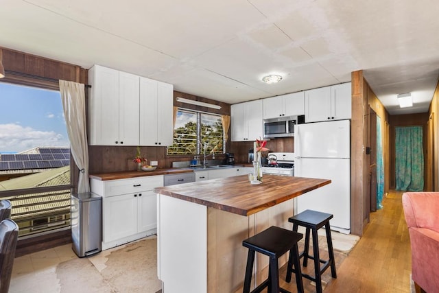 35 Pono St, Hilo, HI 96720 - kitchen with wood counters, white appliances, white cabinets, and a sink