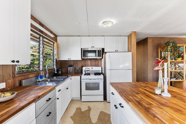 35 Pono St, Hilo, HI 96720 - kitchen with wooden counters, white appliances, a sink, white cabinetry, and wood walls