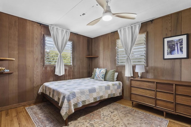35 Pono St, Hilo, HI 96720 - bedroom featuring light wood-style floors, wood walls, and a ceiling fan
