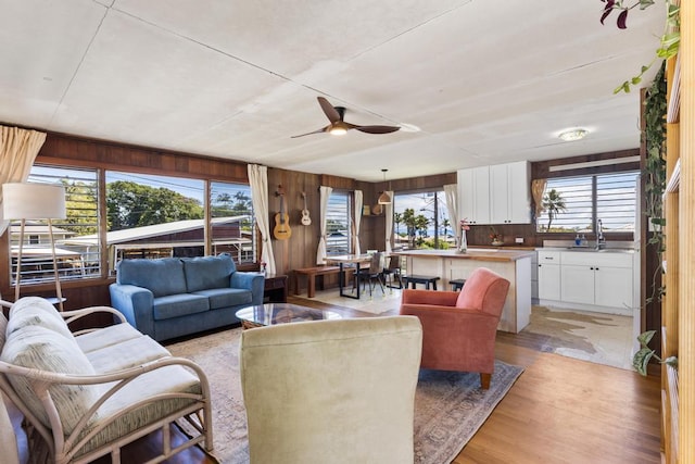 35 Pono St, Hilo, HI 96720 - living area with wood walls, ceiling fan, and light wood finished floors