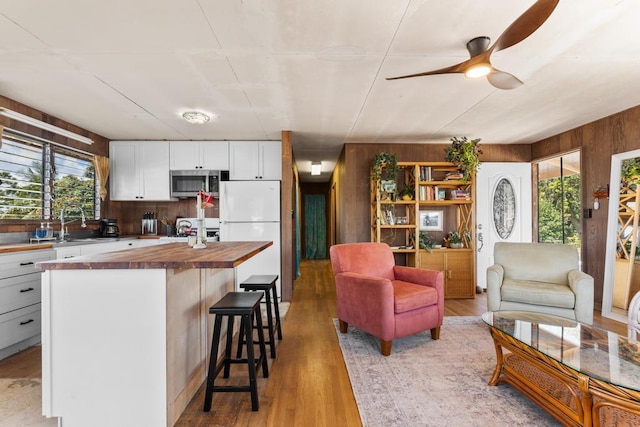 35 Pono St, Hilo, HI 96720 - kitchen featuring wooden counters, stainless steel microwave, freestanding refrigerator, a sink, and plenty of natural light