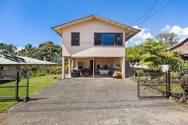 35 Pono St, Hilo, HI 96720 - view of front of house featuring a gate, a carport, driveway, and an outdoor living space
