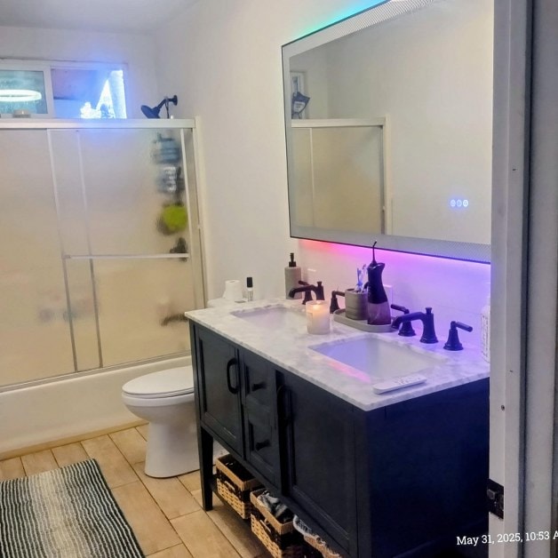 13-3313 Moku St, Pahoa, HI 96778 - full bathroom with toilet, double vanity, tile patterned flooring, and bath / shower combo with glass door