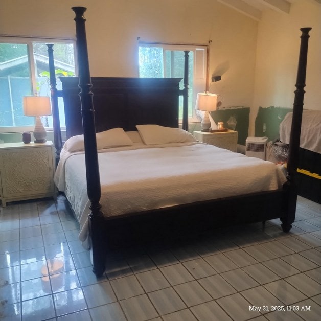 13-3313 Moku St, Pahoa, HI 96778 - bedroom featuring radiator heating unit, tile patterned flooring, multiple windows, and lofted ceiling