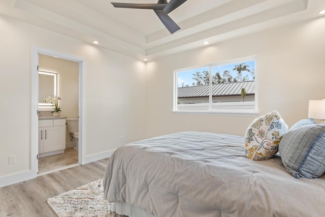 16-2068 Bamboo Dr, Pahoa, HI 96778 - bedroom with light wood-type flooring, ensuite bathroom, recessed lighting, a tray ceiling, and baseboards
