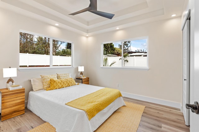 16-2068 Bamboo Dr, Pahoa, HI 96778 - bedroom featuring a raised ceiling, multiple windows, light wood-style flooring, and recessed lighting