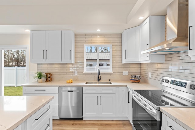 16-2068 Bamboo Dr, Pahoa, HI 96778 - kitchen with stainless steel appliances, wall chimney exhaust hood, a sink, decorative backsplash, and recessed lighting