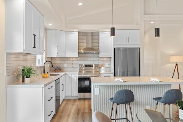 16-2068 Bamboo Dr, Pahoa, HI 96778 - kitchen with wall chimney exhaust hood, appliances with stainless steel finishes, a sink, a breakfast bar area, and vaulted ceiling