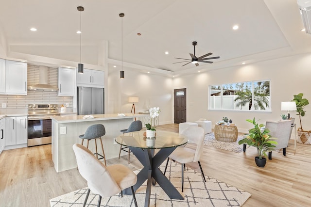 16-2068 Bamboo Dr, Pahoa, HI 96778 - dining room with light wood-style floors, vaulted ceiling, a raised ceiling, a ceiling fan, and recessed lighting