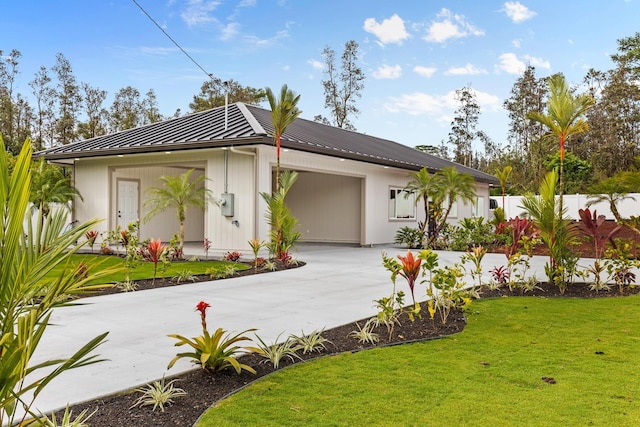 16-2068 Bamboo Dr, Pahoa, HI 96778 - view of front of home with an attached garage, a standing seam roof, driveway, and metal roof