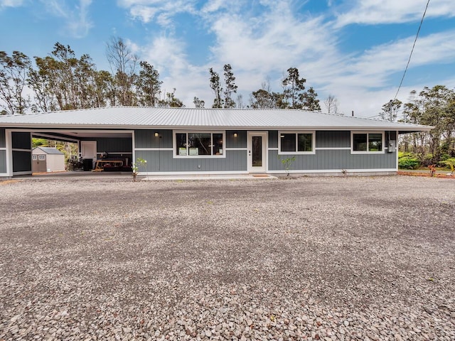 11-3073 Puolani St, Volcano, HI 96785 - view of front of house with metal roof, a carport, and driveway
