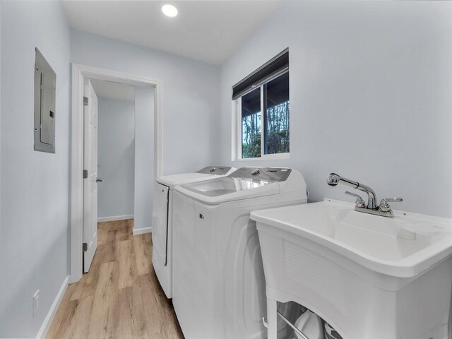 11-3073 Puolani St, Volcano, HI 96785 - laundry room featuring electric panel, light wood-style floors, washer and clothes dryer, and baseboards