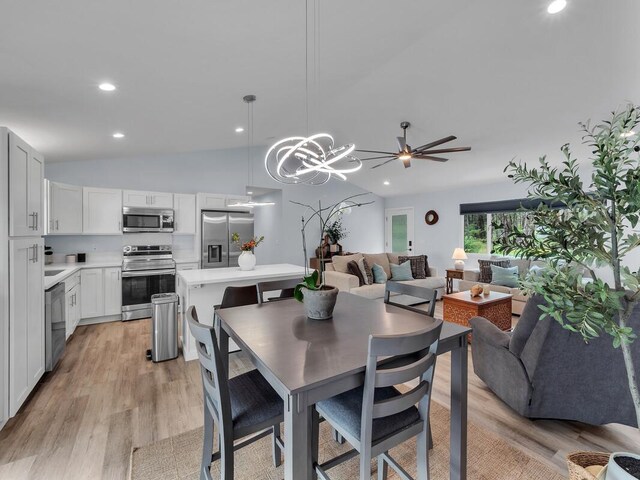 11-3073 Puolani St, Volcano, HI 96785 - dining area with vaulted ceiling, light wood finished floors, ceiling fan, recessed lighting, and a chandelier