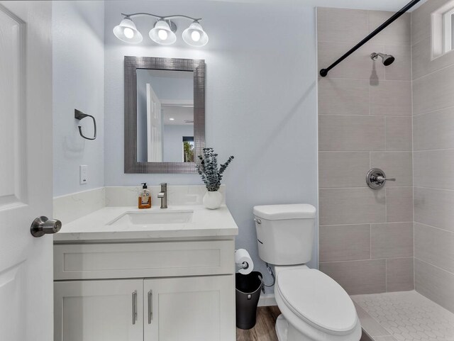 11-3073 Puolani St, Volcano, HI 96785 - full bath with toilet, vanity, tiled shower, and wood finished floors