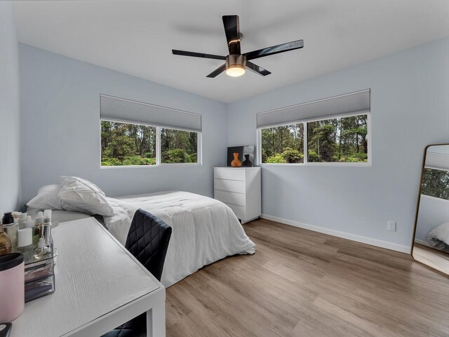 11-3073 Puolani St, Volcano, HI 96785 - bedroom featuring wood finished floors, baseboards, and a ceiling fan