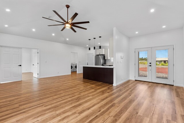 15-1770 10th Ave, Keaau, HI 96749 - unfurnished living room featuring french doors, light wood-type flooring, ceiling fan, washer and dryer, and baseboards