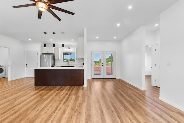 15-1770 10th Ave, Keaau, HI 96749 - kitchen with freestanding refrigerator, light countertops, ceiling fan, washer / dryer, and white cabinets