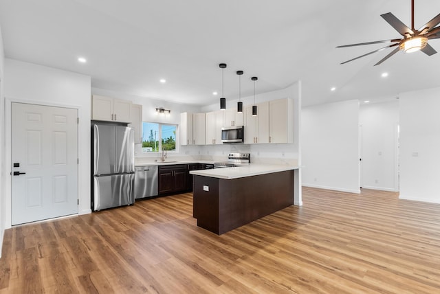15-1770 10th Ave, Keaau, HI 96749 - kitchen featuring stainless steel appliances, a peninsula, light countertops, light wood-style floors, and recessed lighting