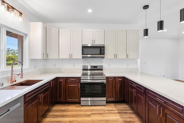 15-1770 10th Ave, Keaau, HI 96749 - kitchen with stainless steel appliances, a sink, pendant lighting, light wood-style floors, and recessed lighting