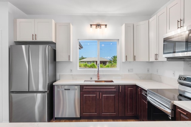 15-1770 10th Ave, Keaau, HI 96749 - kitchen with appliances with stainless steel finishes, a sink, light stone counters, and white cabinets