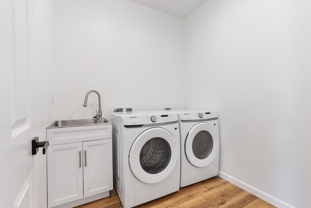 15-1770 10th Ave, Keaau, HI 96749 - laundry area with cabinet space, washing machine and dryer, light wood finished floors, and baseboards