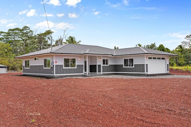 15-1770 10th Ave, Keaau, HI 96749 - view of front of property with an attached garage, metal roof, board and batten siding, and gravel driveway