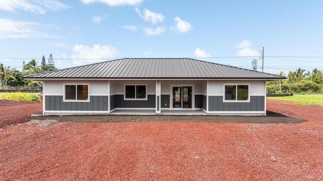 15-1770 10th Ave, Keaau, HI 96749 - view of front facade with board and batten siding, metal roof, and a patio
