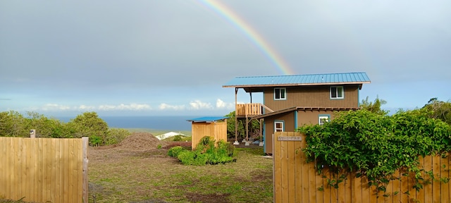 94-6479 Puukani Rd, Naalehu, HI 96772 - view of side of home featuring metal roof and a water view