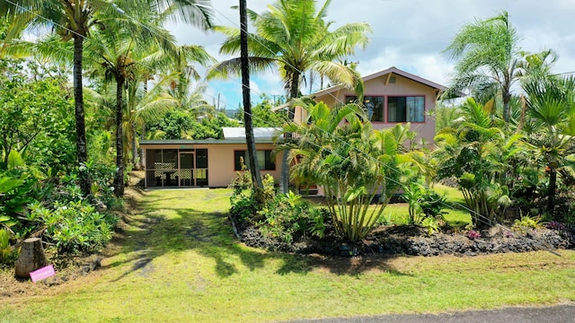 12-7040 Kaihalulu St, Pahoa, HI 96778 - rear view of house featuring a lawn