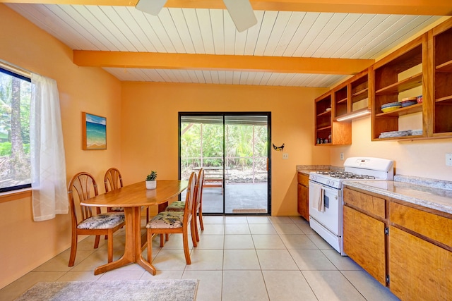 12-7040 Kaihalulu St, Pahoa, HI 96778 - kitchen with white gas stove, light countertops, open shelves, light tile patterned floors, and ceiling fan