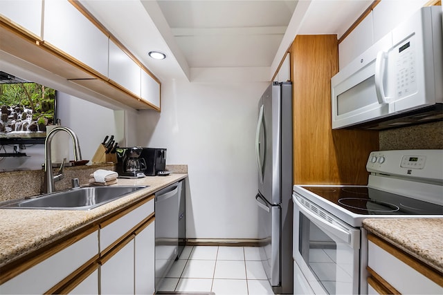 2253 Poipu Rd Unit 230, Koloa, HI 96756 - kitchen featuring appliances with stainless steel finishes, light countertops, white cabinetry, and light tile patterned flooring