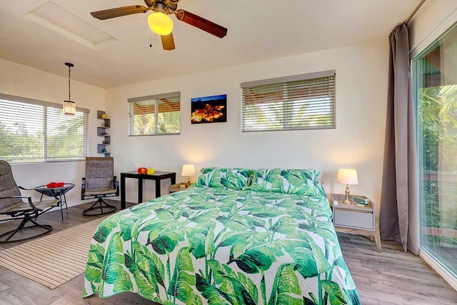 12-7036 Kaiwa St, Pahoa, HI 96778 - bedroom with wood finished floors, a ceiling fan, and attic access